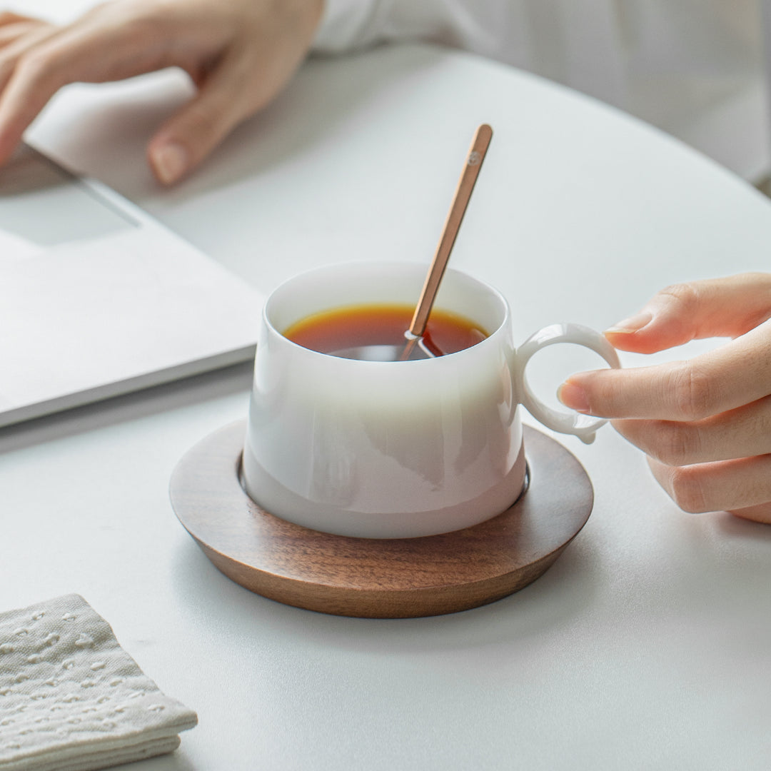 white coffee cup with wood saucer