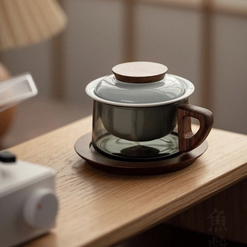 tea mug with lid, filter, and wood saucer