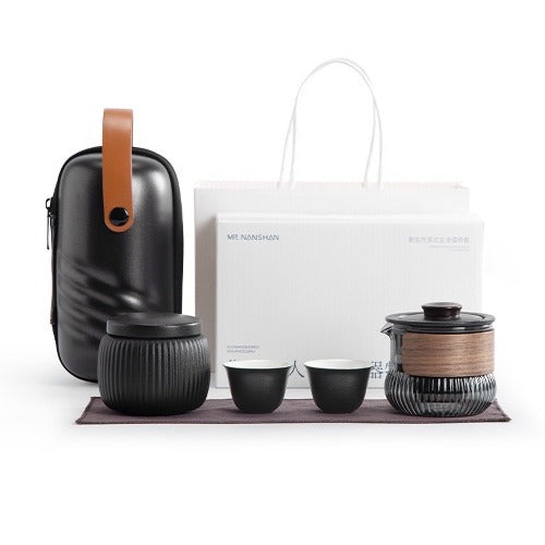 Elegant travel tea set featuring a ceramic teapot, two matching cups, and a durable carrying case.