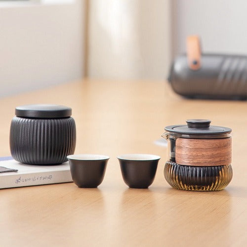 Portable tea set including teapot and cups in a convenient travel case."