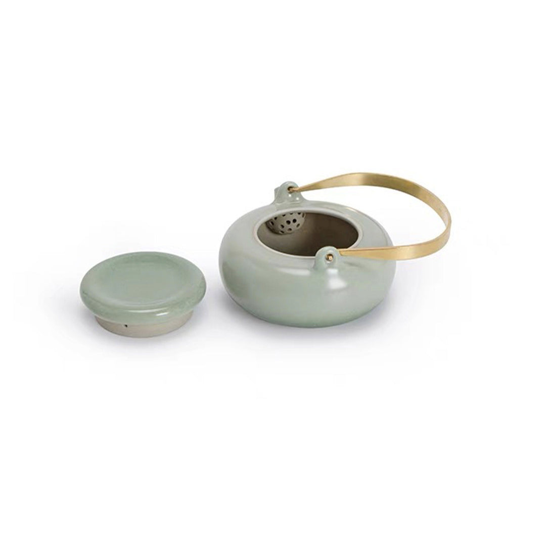 green ceramic teapot with top handle