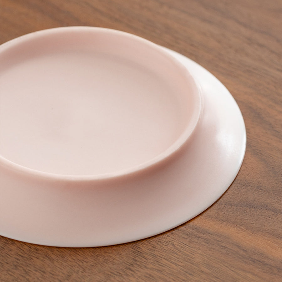 Pink silicone mat on a wooden surface