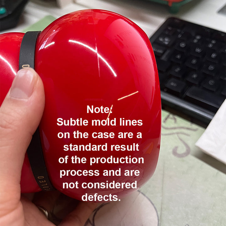 Red case with mold lines held by a hand, keyboard in the background