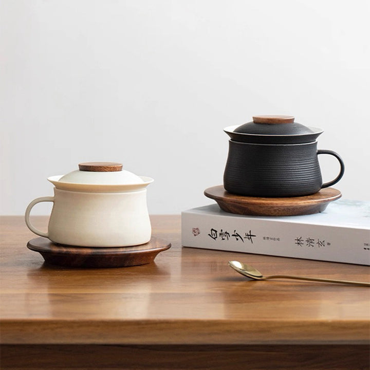 black and cream coffee and coffee mug with lid and saucer 